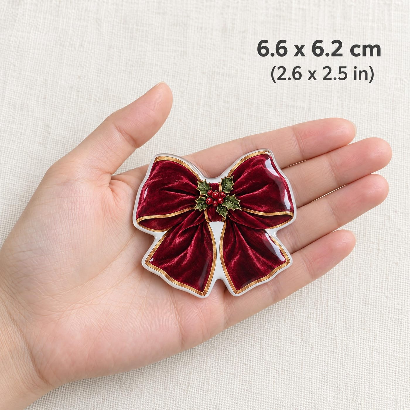 Velvet Bow with Holly Christmas Resin Fridge Magnet shown in hand for scale